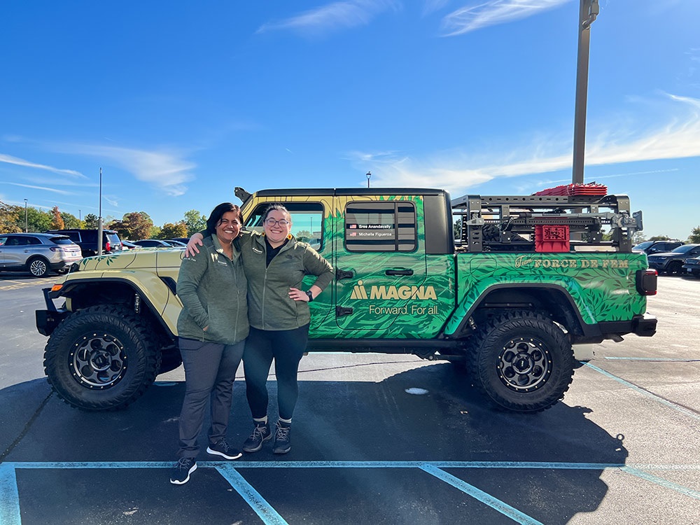 Two people standing outside of Jeep® Gladiator Rubicon with Magna logo in parking lot