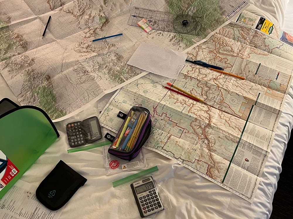 Maps, calculators, rulers and pencil laid out