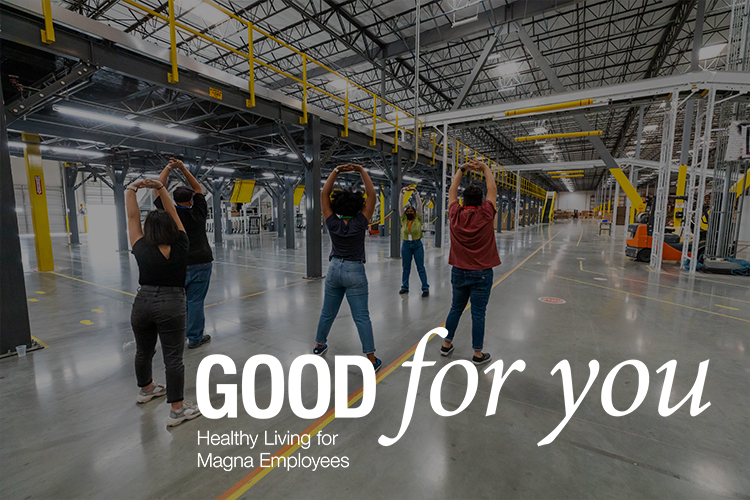 Group of people doing exercises in a manufacturing facility.