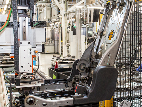 Frame of a vehicle bucket seat in a manufacturing facility