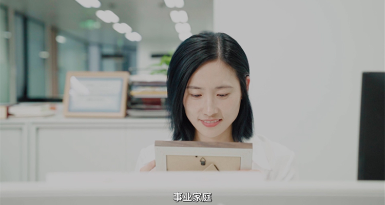 Mona Li sitting at desk in office