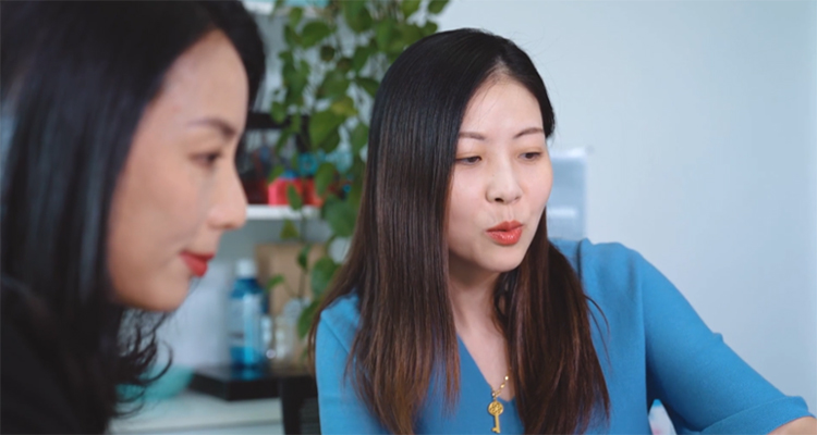 Peggy Li in a meeting with a colleague