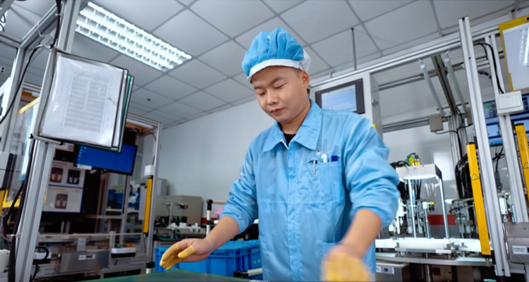 Wu Zhanggang working in a manufacturing plant