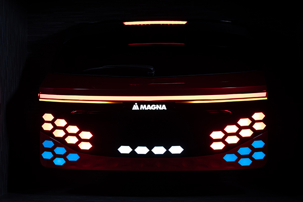 Back of a magna car with red, yellow and blue light and black background