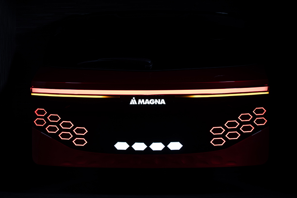 Back of a magna car with red and yellow light and black background