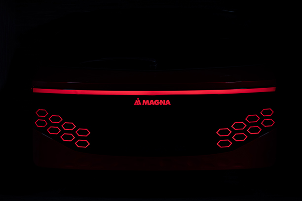 Back of a magna car with red light and black background