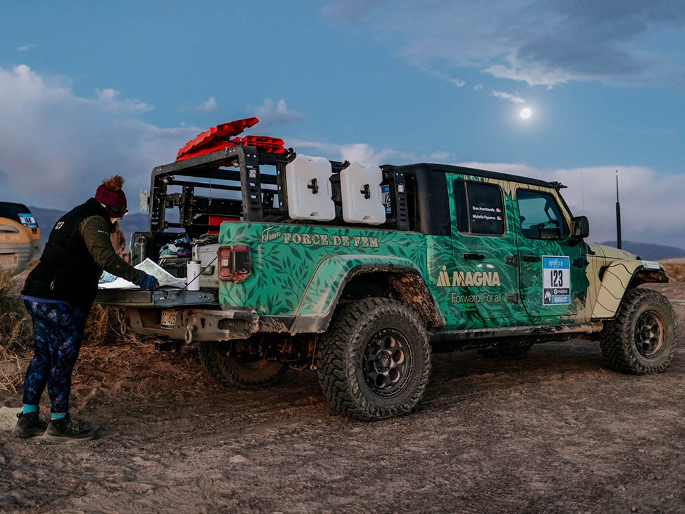 Michelle Figueroa standing behind Jeep® Gladiator Rubicon looking at a map