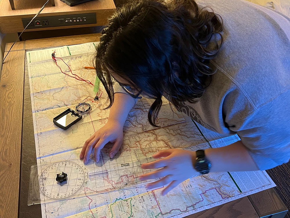 Michelle Figueroa looking at a map and plotting a route