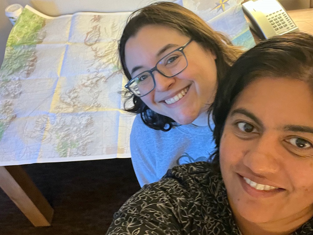 Michelle Figueroa and Sree Anandavally taking a selfie with a map in background