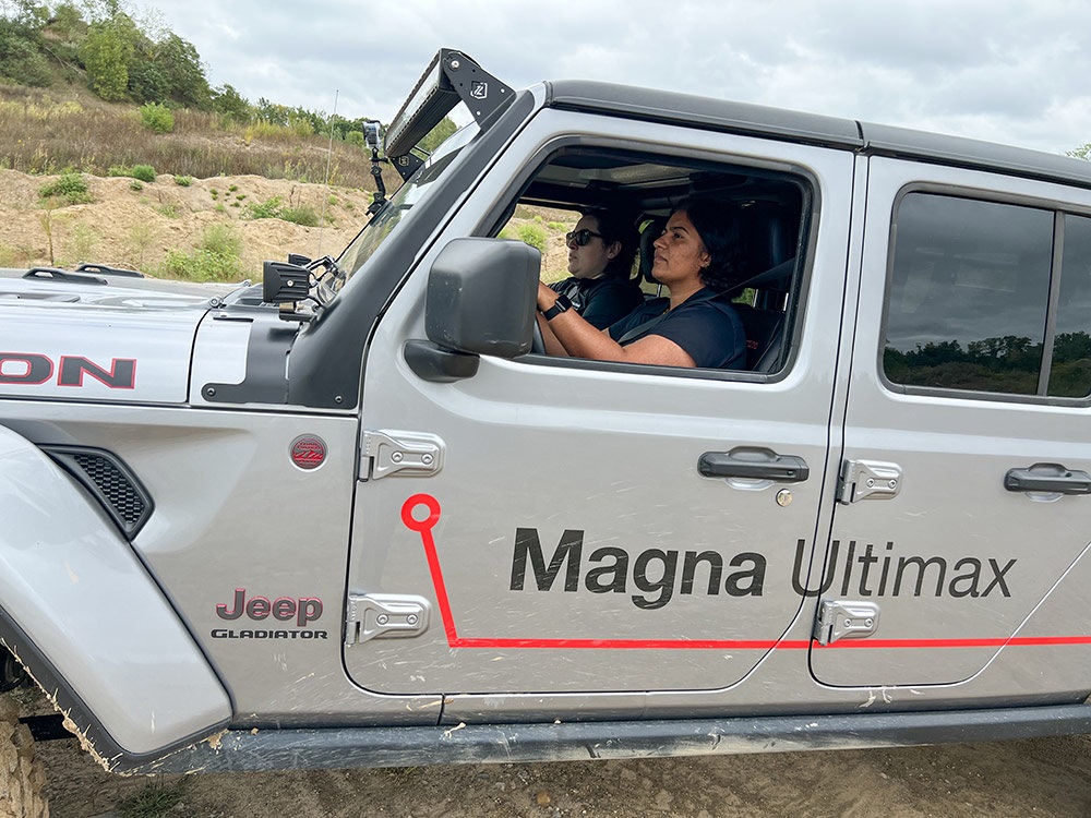 Two people driving a Jeep® Gladiator Rubicon along rugged terrain