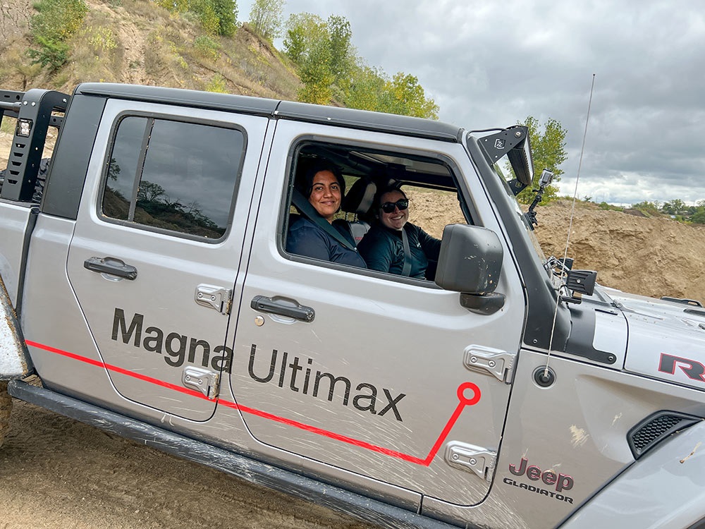 Two people driving a Jeep® Gladiator Rubicon along rugged terrain