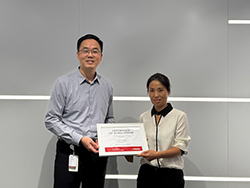 Two people standing together holding a certificate