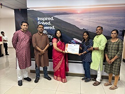 Group of standing together with two people in the middle holding a certificate