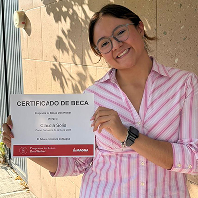 Claudia Estefania Solis Franco holding the Don Walker Scholarship Program Award