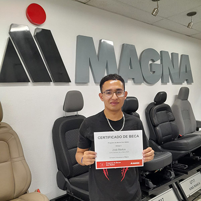 Jose Guadalupe Maltos Vallejoa holding the Don Walker Scholarship Program Award