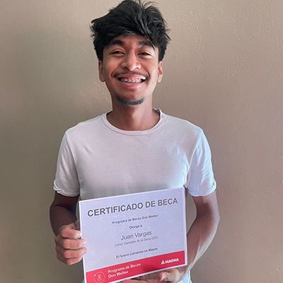 Juan Carlos Vargas De la Rosa holding the Don Walker Scholarship Program Award