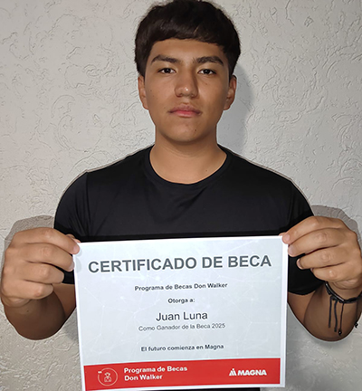 Juan Luna Castillo holding the Don Walker Scholarship Program Award