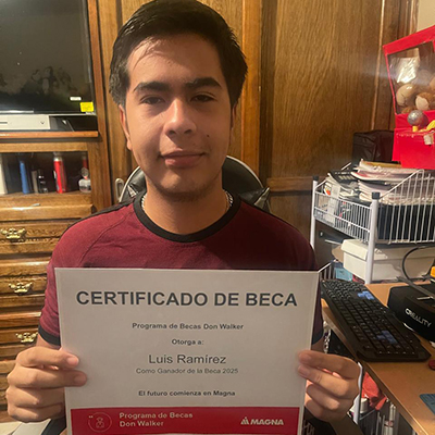 Luis Eduardo Ramirez Valdez holding the Don Walker Scholarship Program Award