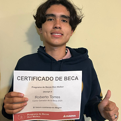 Roberto Evans Torres Aguirre holding the Don Walker Scholarship Program Award