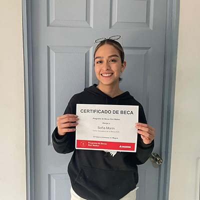 Sofia Yareli Morin Rodriguez holding the Don Walker Scholarship Program Award