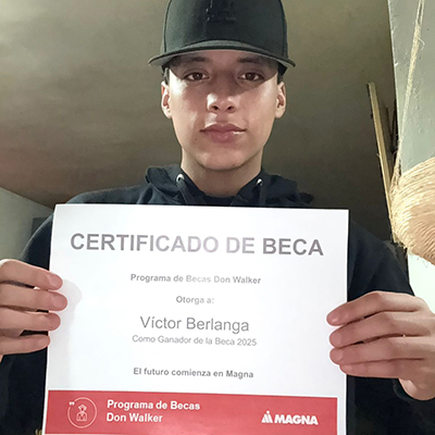 Victor Alejandro Berlanga Araiza holding the Don Walker Scholarship Program Award