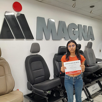 Wendy Isabel Cruces Zavala holding the Don Walker Scholarship Program Award