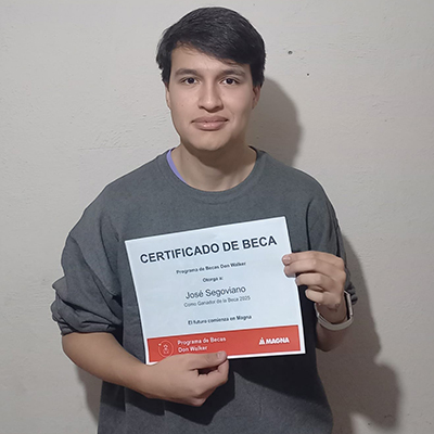 Jose Segoviano holding the Don Walker Scholarship Program Award