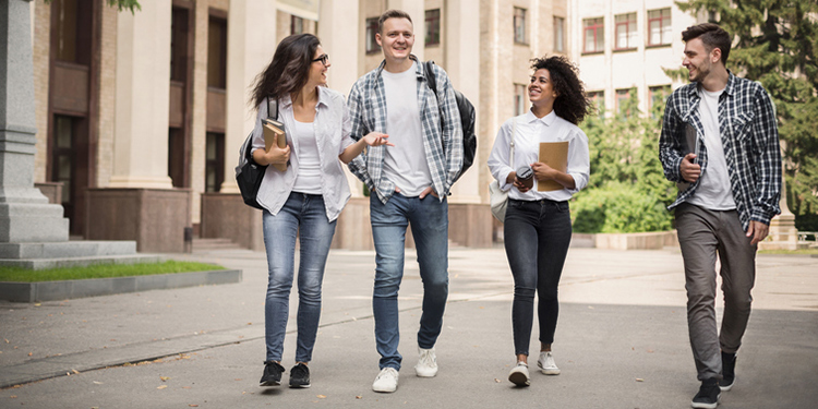 Group of students walking through a college campus