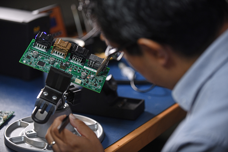 Person working on a circuit board