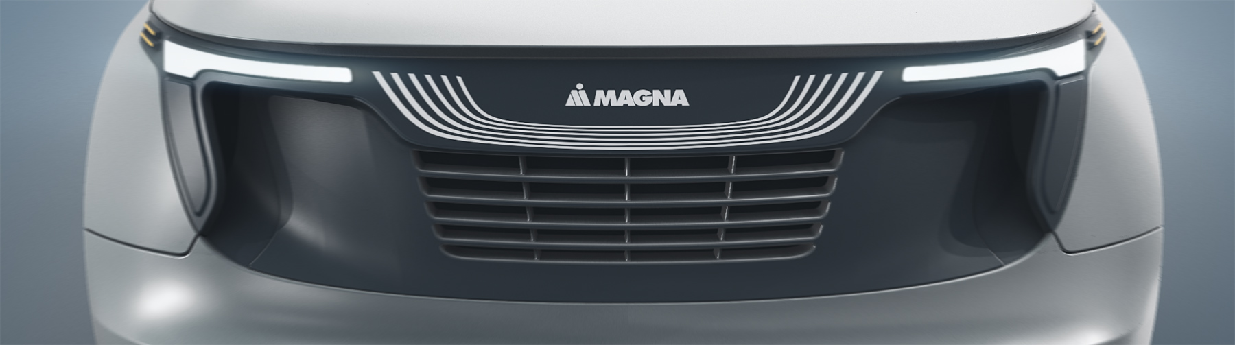 Front grill of a vehicle with Magna logo