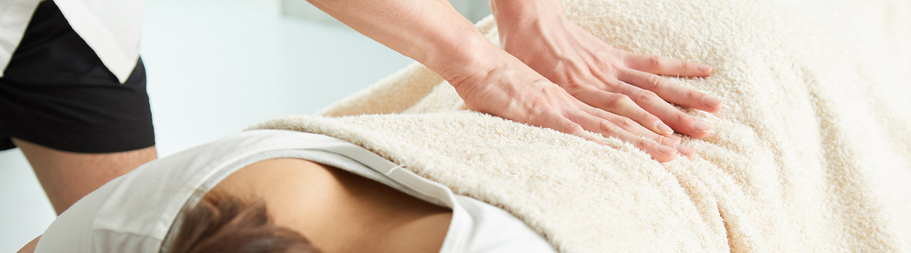 Person providing massage therapy to a patient