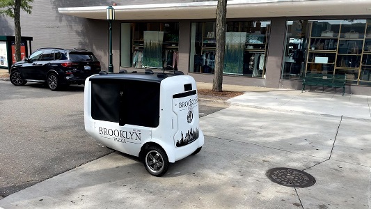 Photo of Delivery Bot driving along street