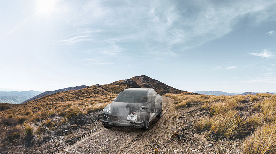 Vehicle driving on a gravel road ghosted showing Range Extension &amp; Hybrids DHD REX and DHD Duo