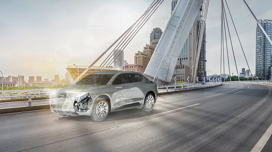 Vehicle driving over a bridge ghosted to show electrified powertrain system BEV &amp; DHD