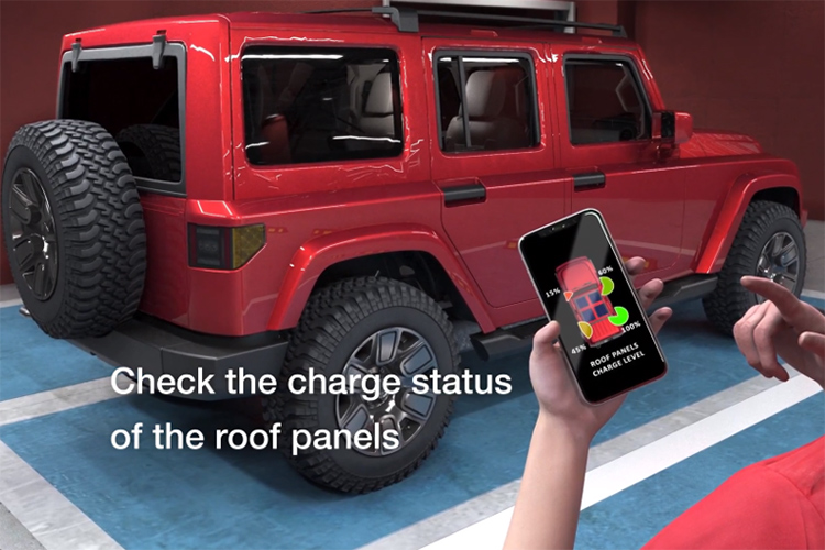 Person standing outside of a red vehicle with a smartphone checking charge status of roof panels
