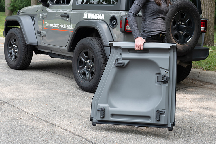 Person carrying thermoplastic roof panel