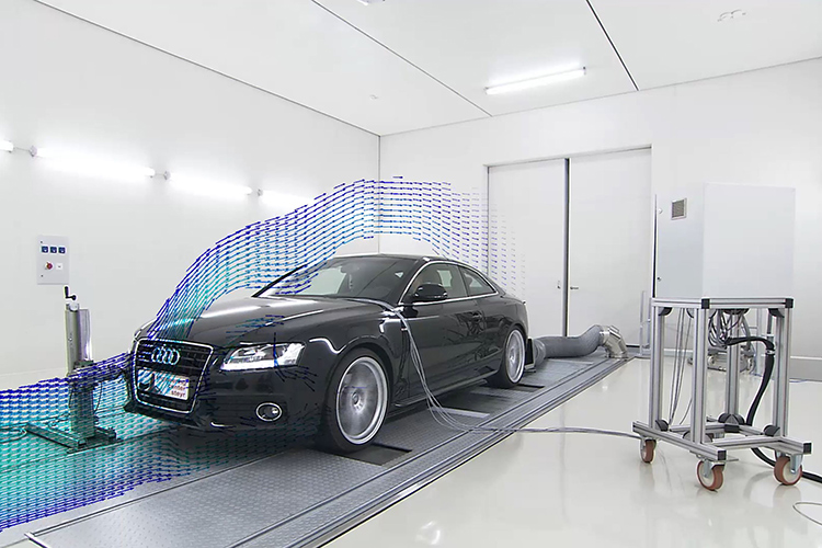 Black vehicle on a 4WD Chassis Dynamometer in a manufacturing facility, showing airflow over the vehicle.