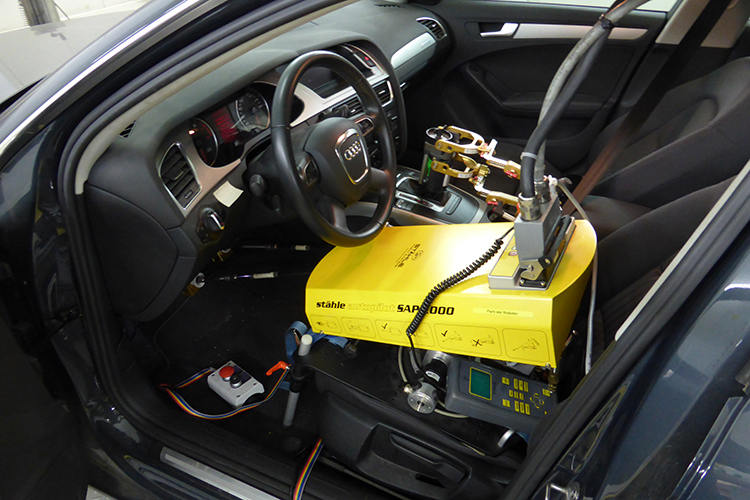 Interior of a vehicle with a driving robot used to enable highly repeatable test execution