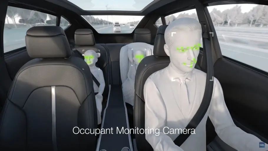 Three people in a car showing the occupant monitoring camera capabilities