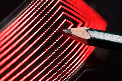 Picture of a rectangular FlecsForm panel with the tip of a sharpened pencil