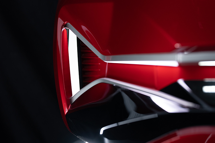 Front end of red vehicle showing morphing surfaces technology