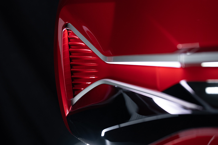 Front end of red vehicle showing morphing surfaces technology