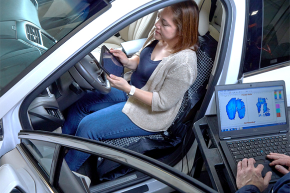 Person sitting in car testing comfort of car seats