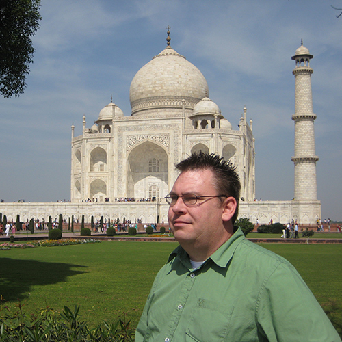 Doug Plester standing in front of a temple in India