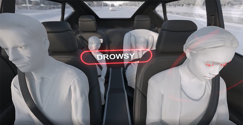 Animation of a person driving a vehicle and the driver monitoring system detecting they are drowsy