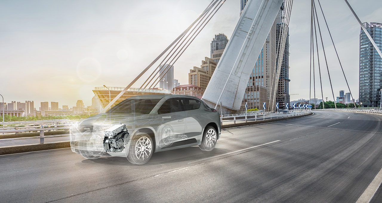 Ghosted grey vehicle showing engine driving along a bridge with cityscape in the background