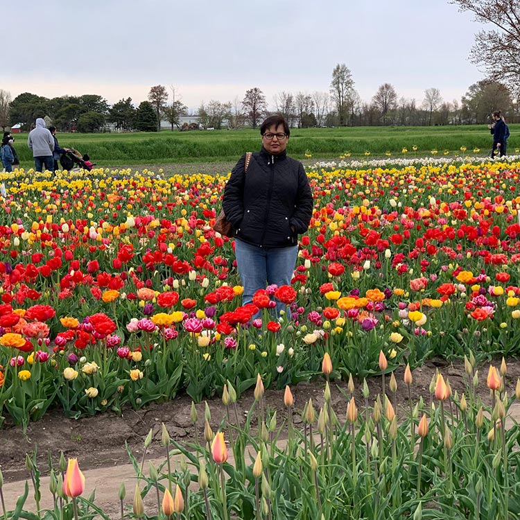 Anagha Wankar standing in a field of tulips in Holland