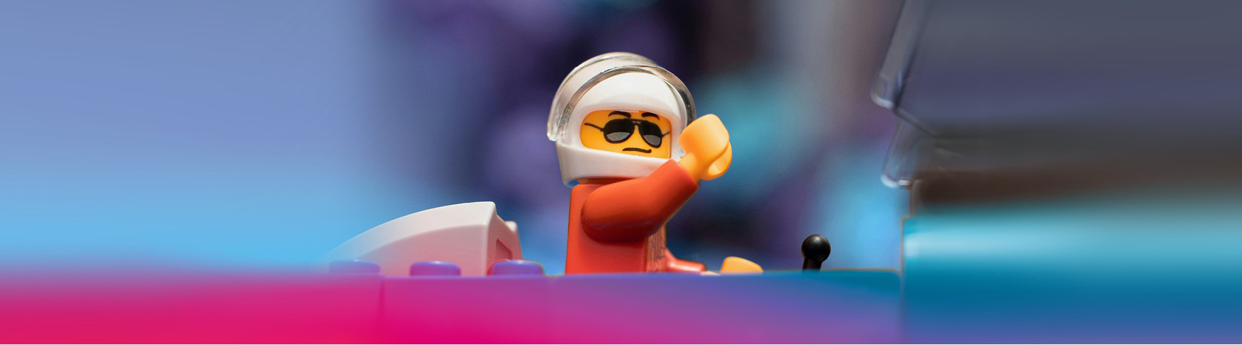 Lego figure with a helmet in a car