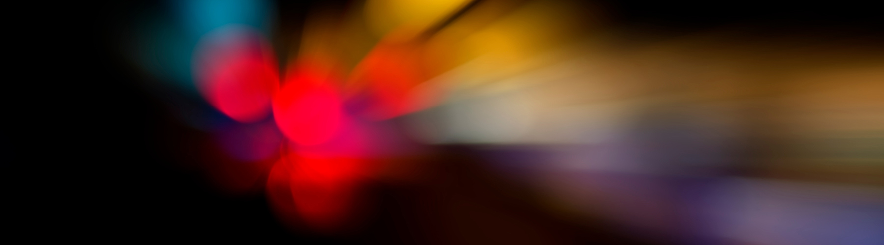 Abstract image with red dots and orange, white, purple and blue blurred lines