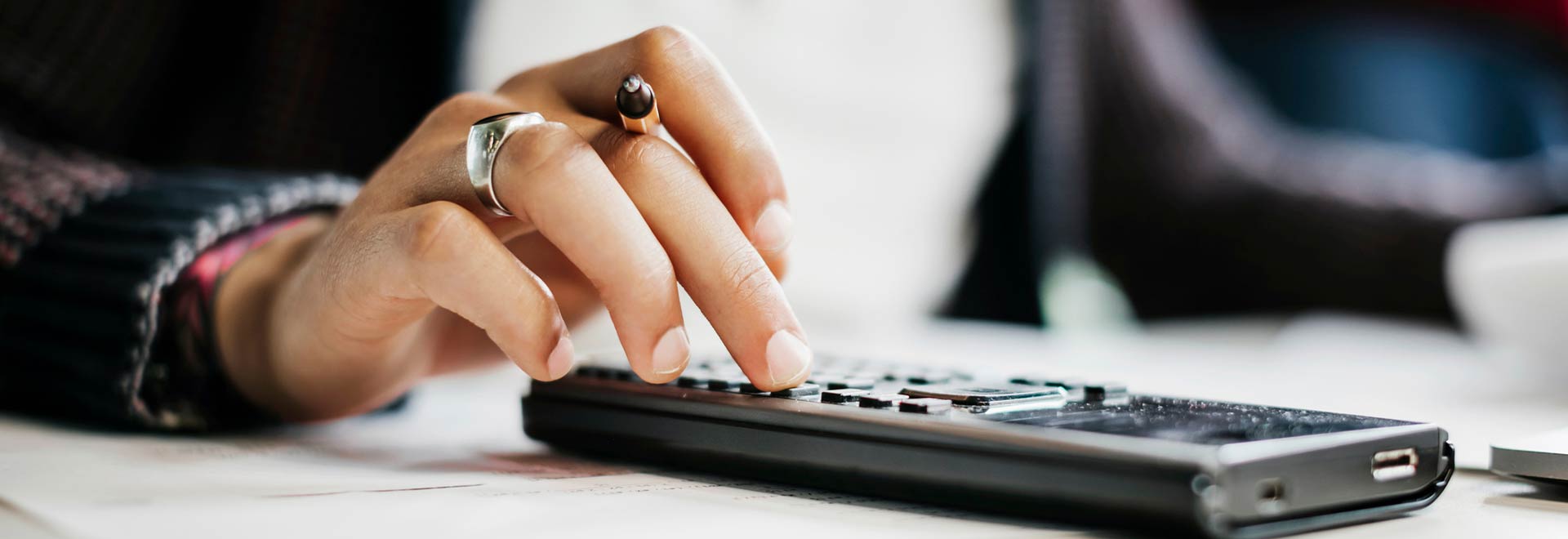 hand with a pocket calculator